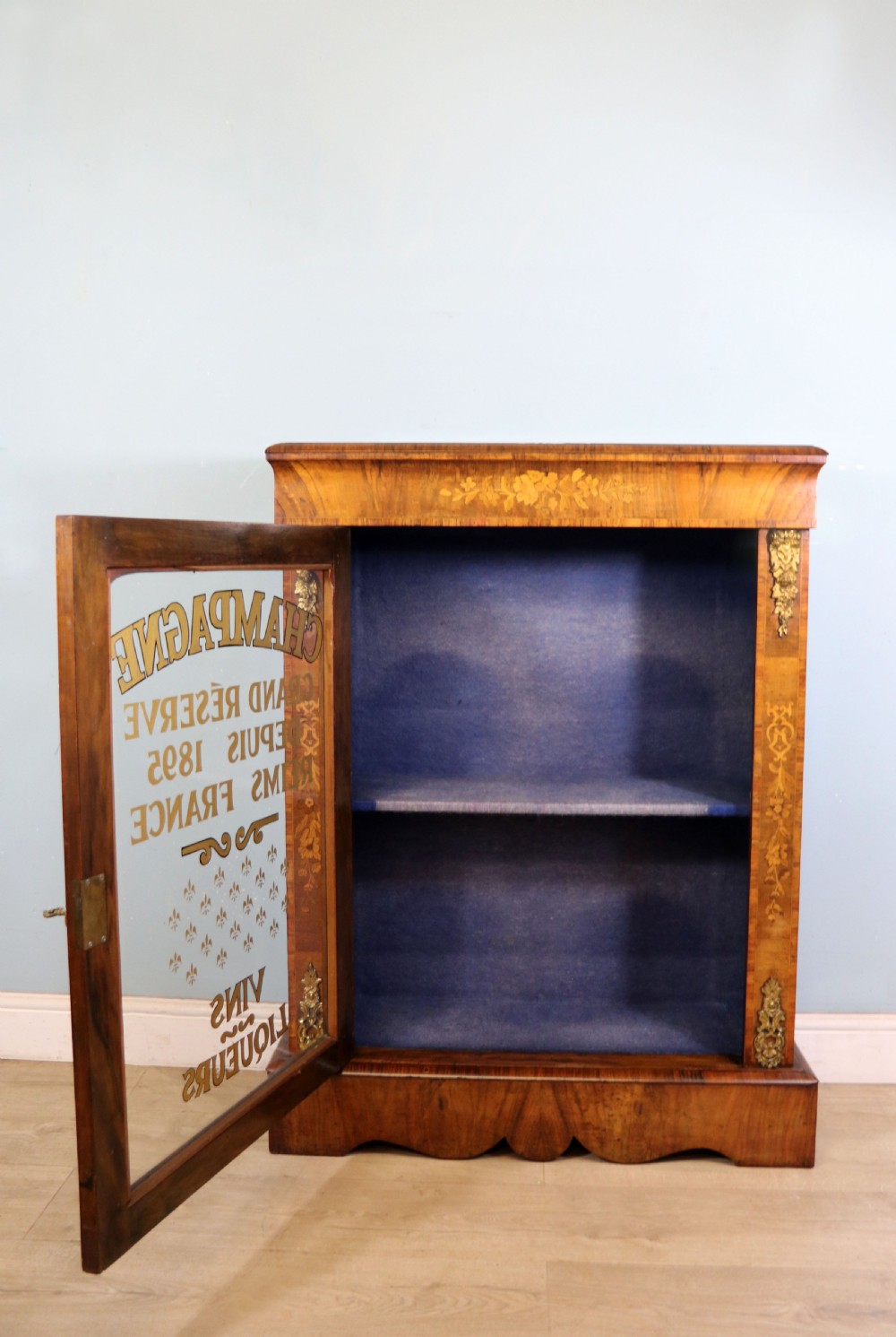 A lovely Victorian walnut and floral inlaid pier cabinet, later sign written in French with Champagne advertising. View II