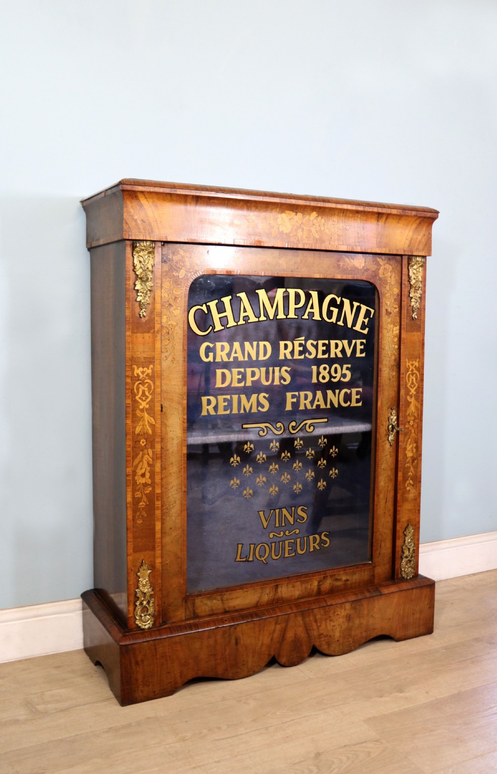 A lovely Victorian walnut and floral inlaid pier cabinet, later sign written in French with Champagne advertising. View III