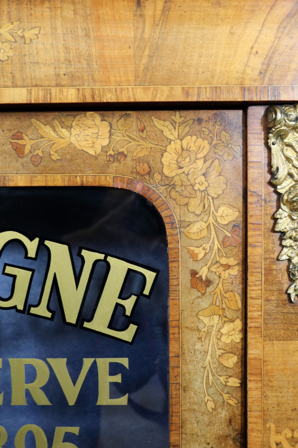 A lovely Victorian walnut and floral inlaid pier cabinet, later sign written in French with Champagne advertising. View XIV