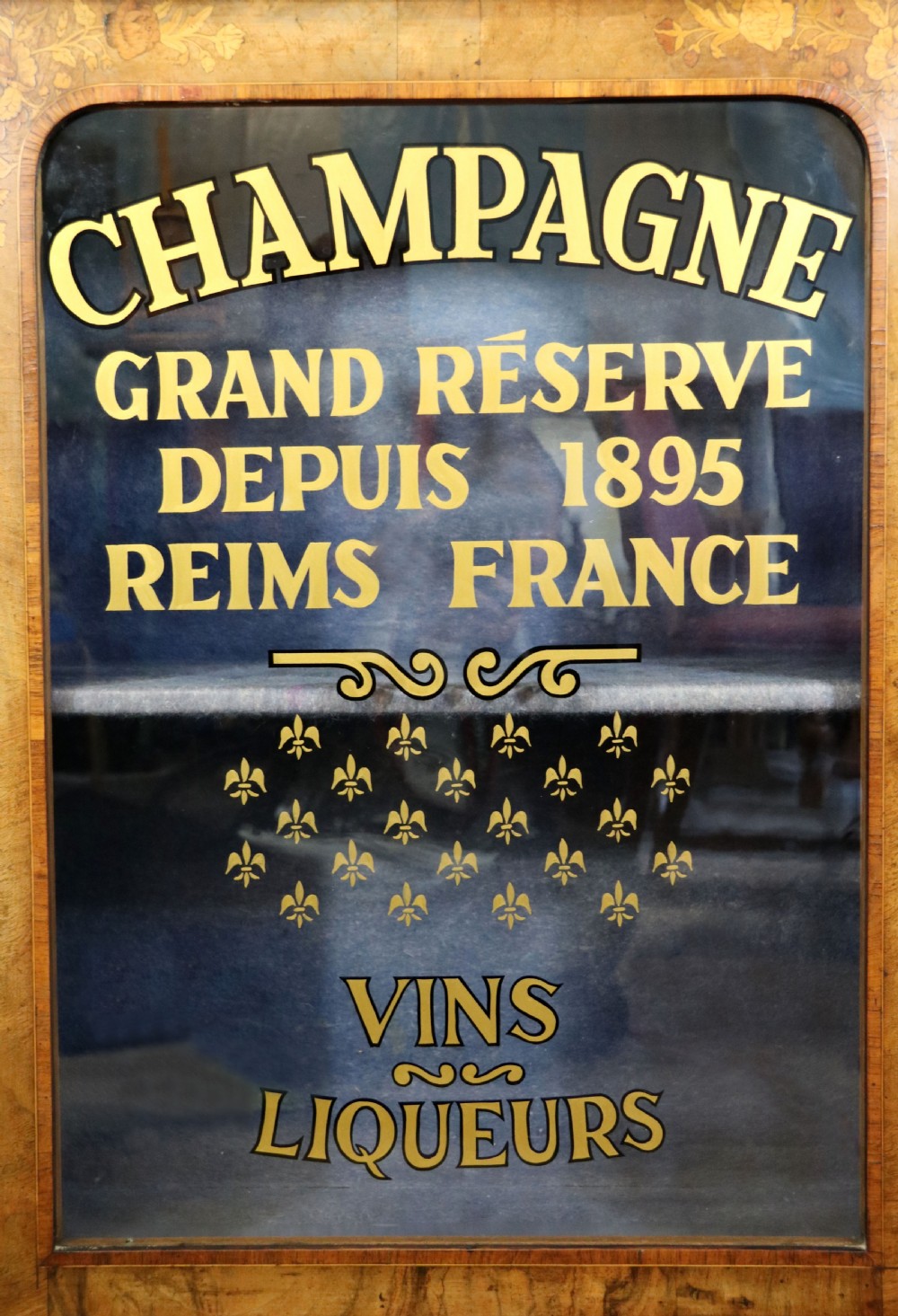 A lovely Victorian walnut and floral inlaid pier cabinet, later sign written in French with Champagne advertising. View XV