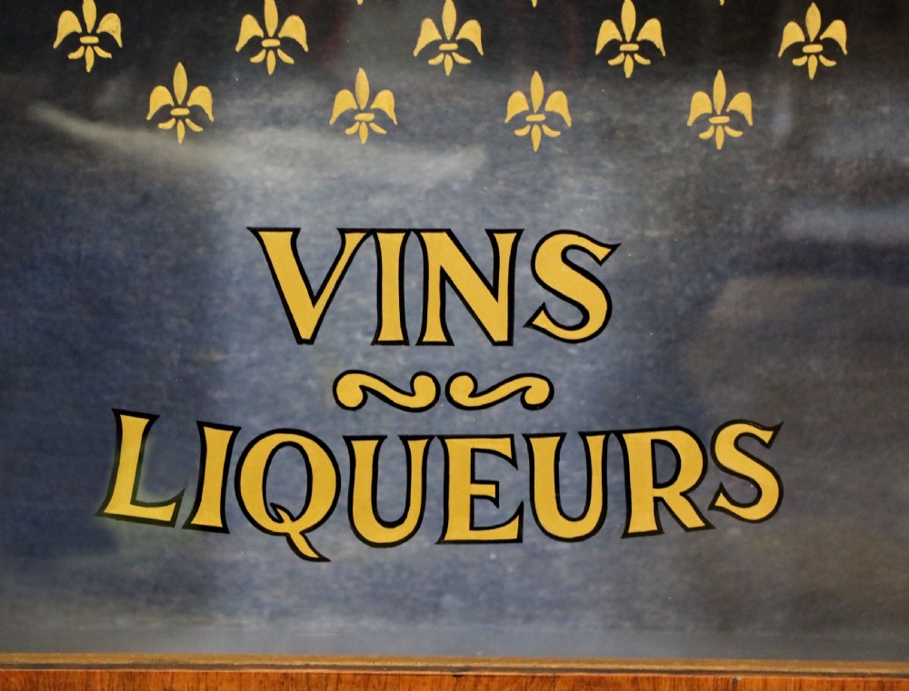 A lovely Victorian walnut and floral inlaid pier cabinet, later sign written in French with Champagne advertising. View XIX
