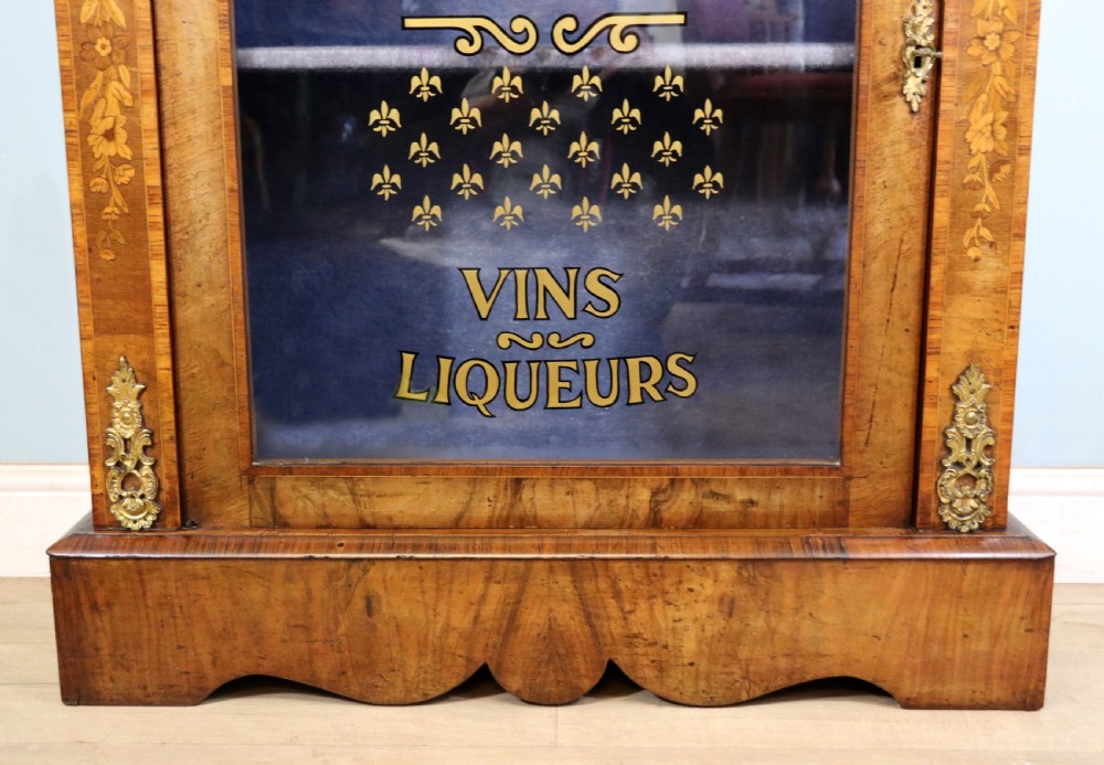 A lovely Victorian walnut and floral inlaid pier cabinet, later sign written in French with Champagne advertising. View XX