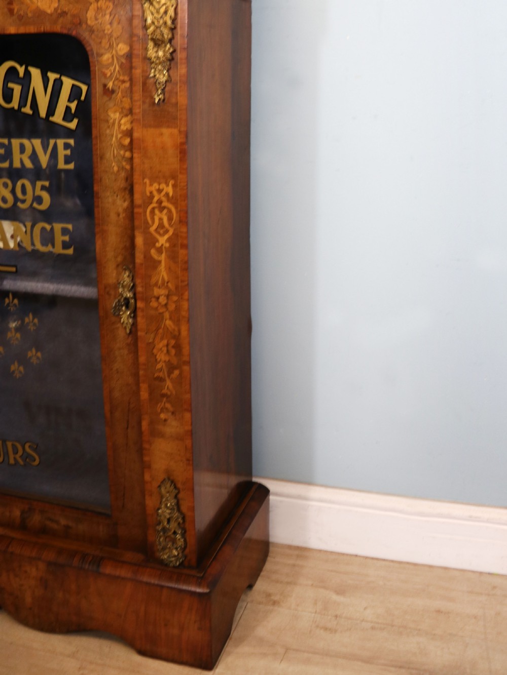 A lovely Victorian walnut and floral inlaid pier cabinet, later sign written in French with Champagne advertising. View XXV