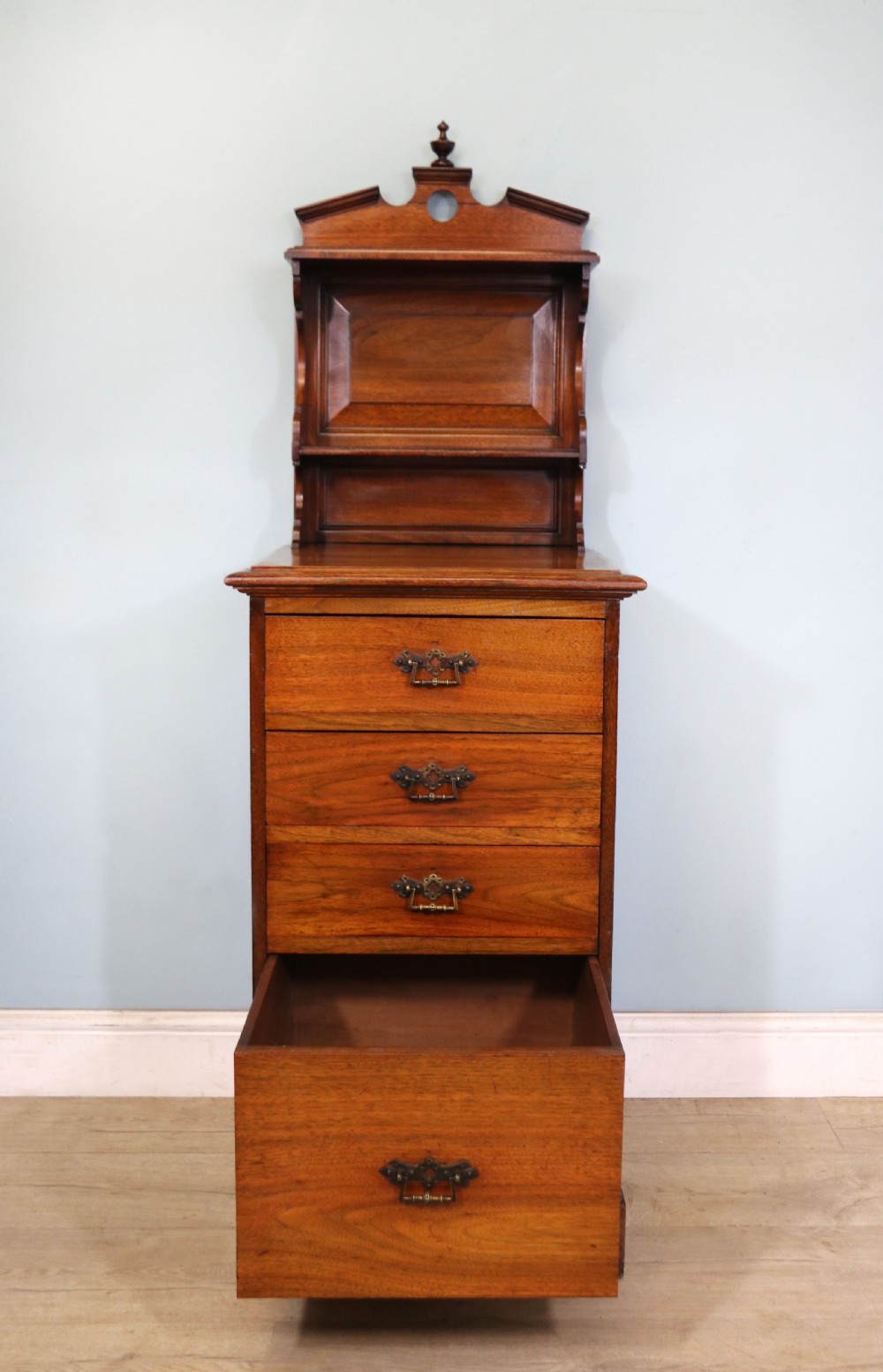 A late 19th century American walnut pedestal chest. View IV