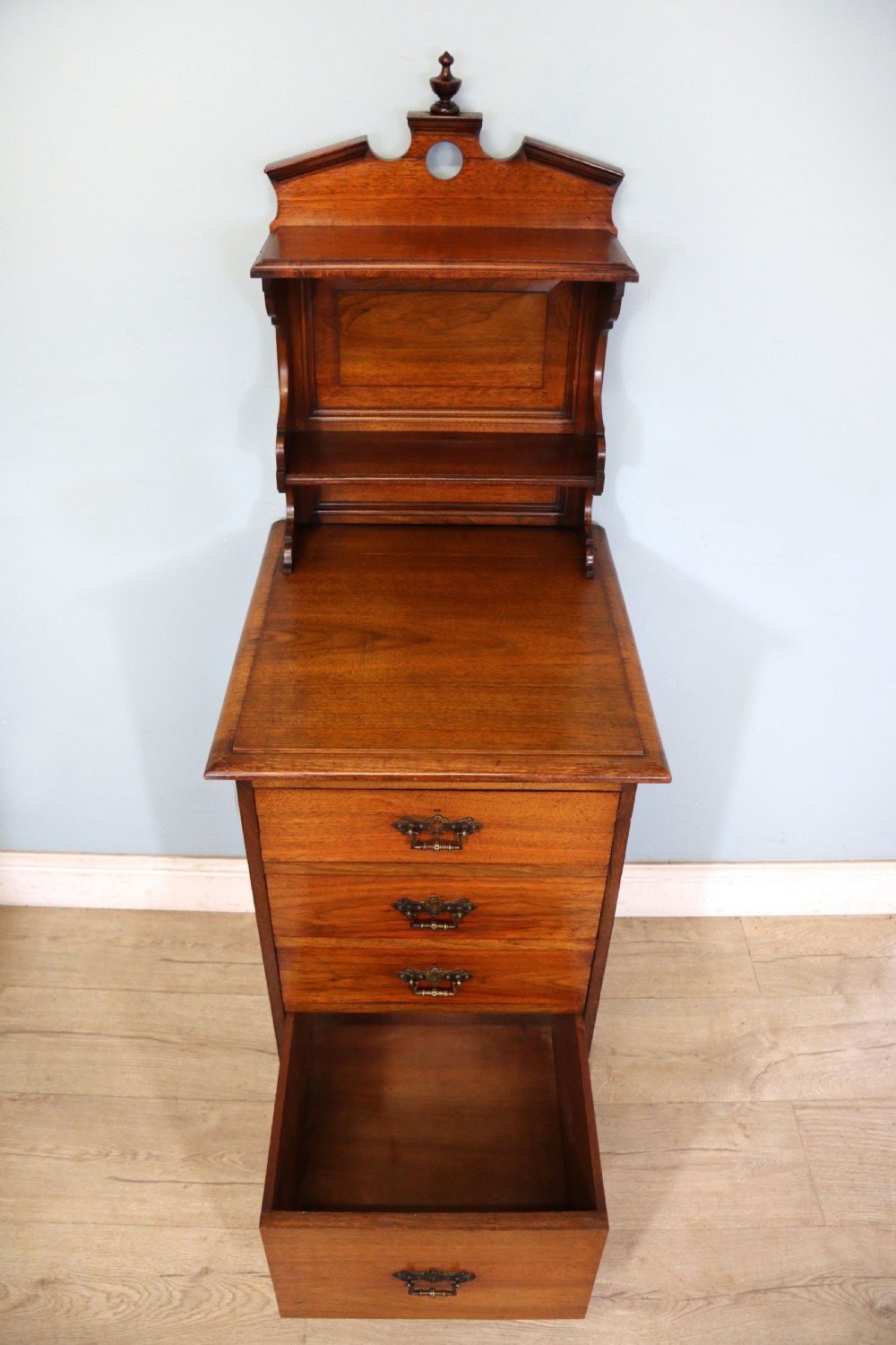 A late 19th century American walnut pedestal chest. View V