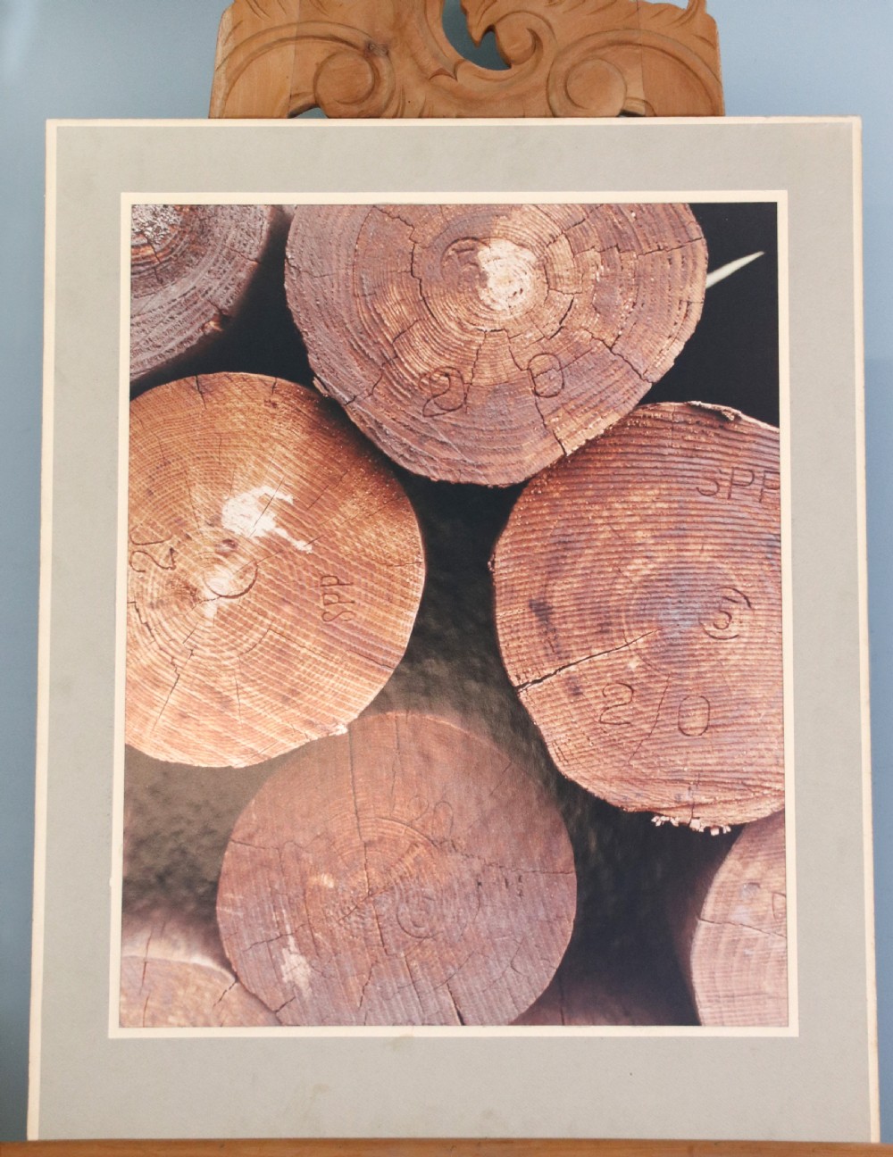 A mounted mid-century colour photograph depicting a foundry worker pouring molten metal. View VI