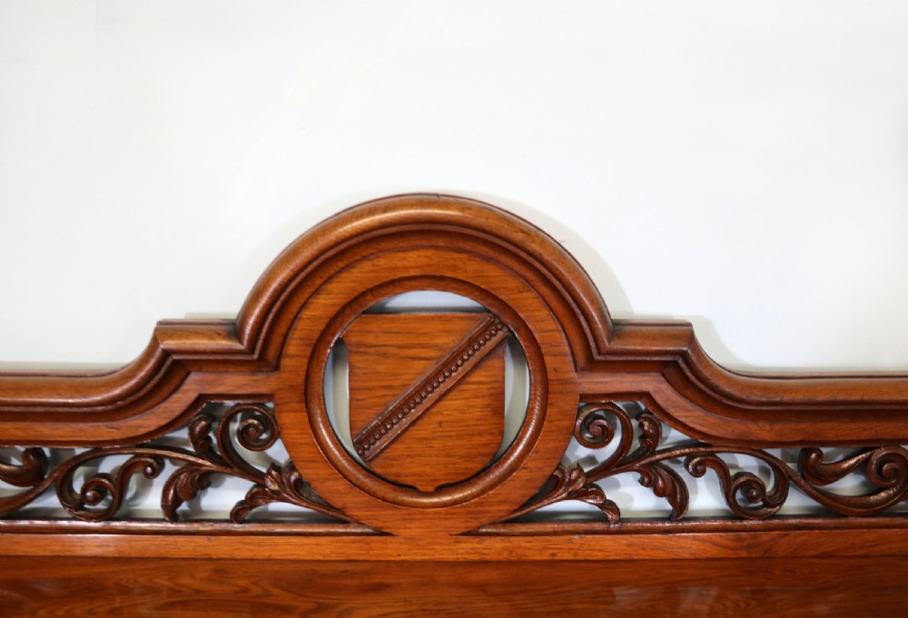 A Victorian pollard oak sideboard featuring a carved upper display shelf, fretwork cresting, and two fielded panel doors with decorative wood grain. View VII