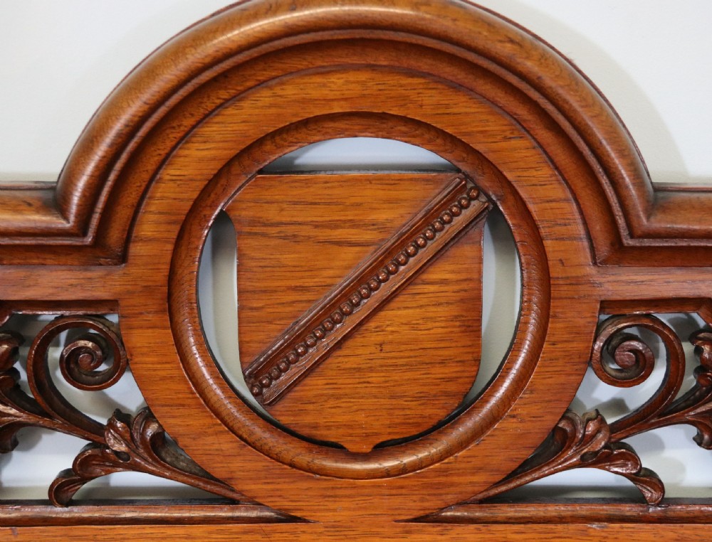 A Victorian pollard oak sideboard featuring a carved upper display shelf, fretwork cresting, and two fielded panel doors with decorative wood grain. View IX