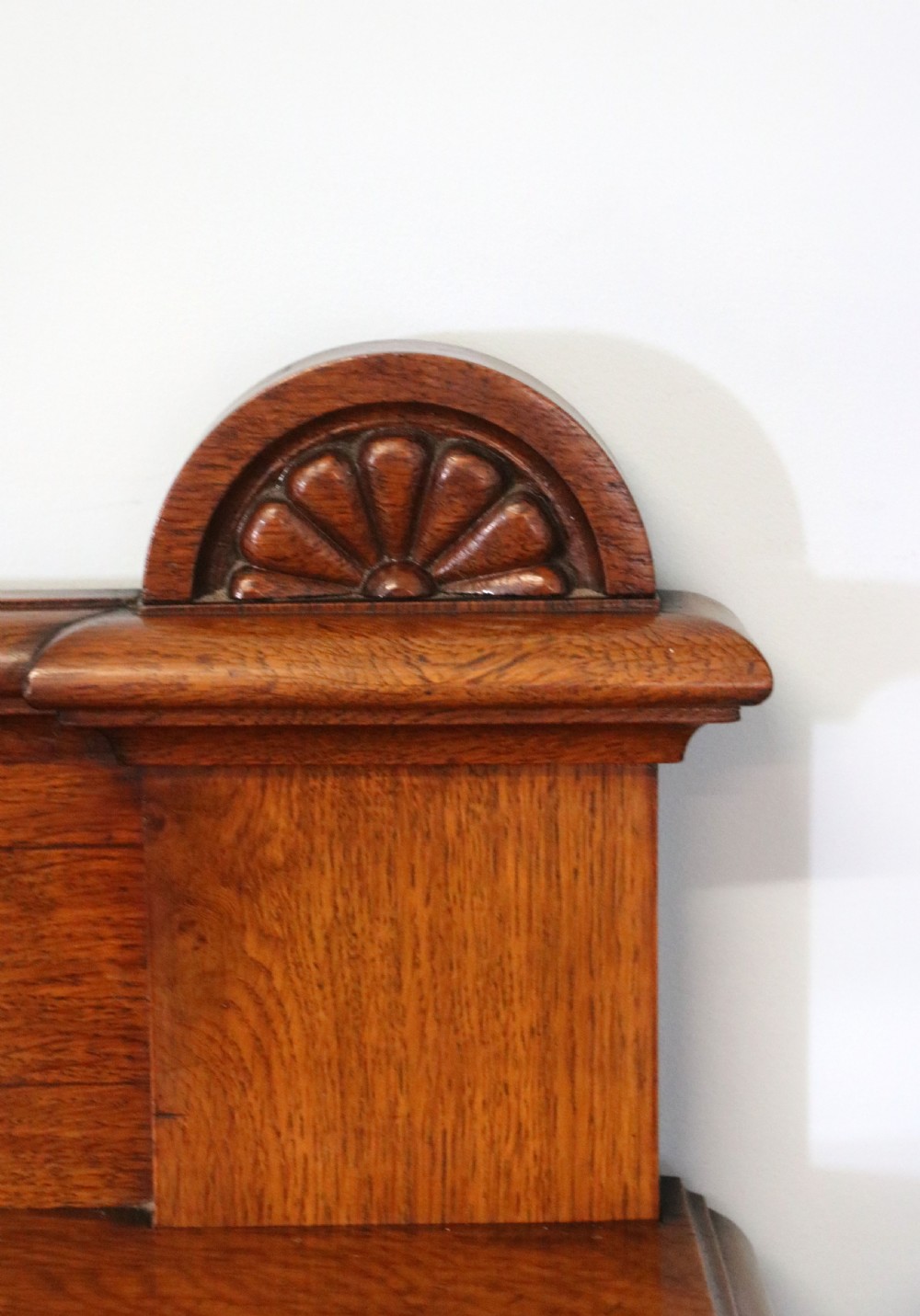 A Victorian pollard oak sideboard featuring a carved upper display shelf, fretwork cresting, and two fielded panel doors with decorative wood grain. View XI