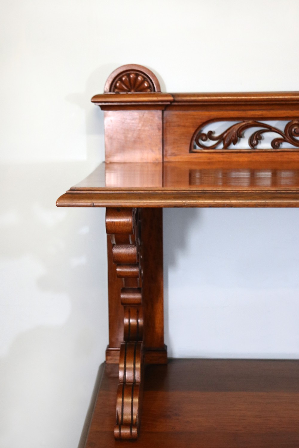 A Victorian pollard oak sideboard featuring a carved upper display shelf, fretwork cresting, and two fielded panel doors with decorative wood grain. View XV