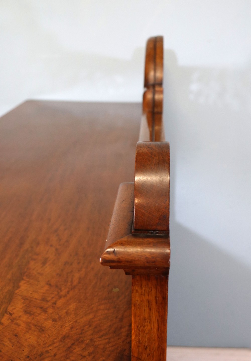 A Victorian pollard oak sideboard featuring a carved upper display shelf, fretwork cresting, and two fielded panel doors with decorative wood grain. View XIX