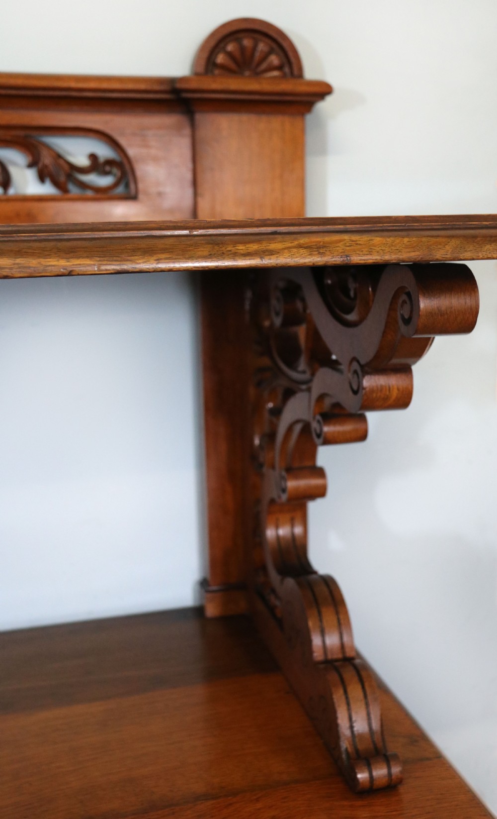 A Victorian pollard oak sideboard featuring a carved upper display shelf, fretwork cresting, and two fielded panel doors with decorative wood grain. View XXIII