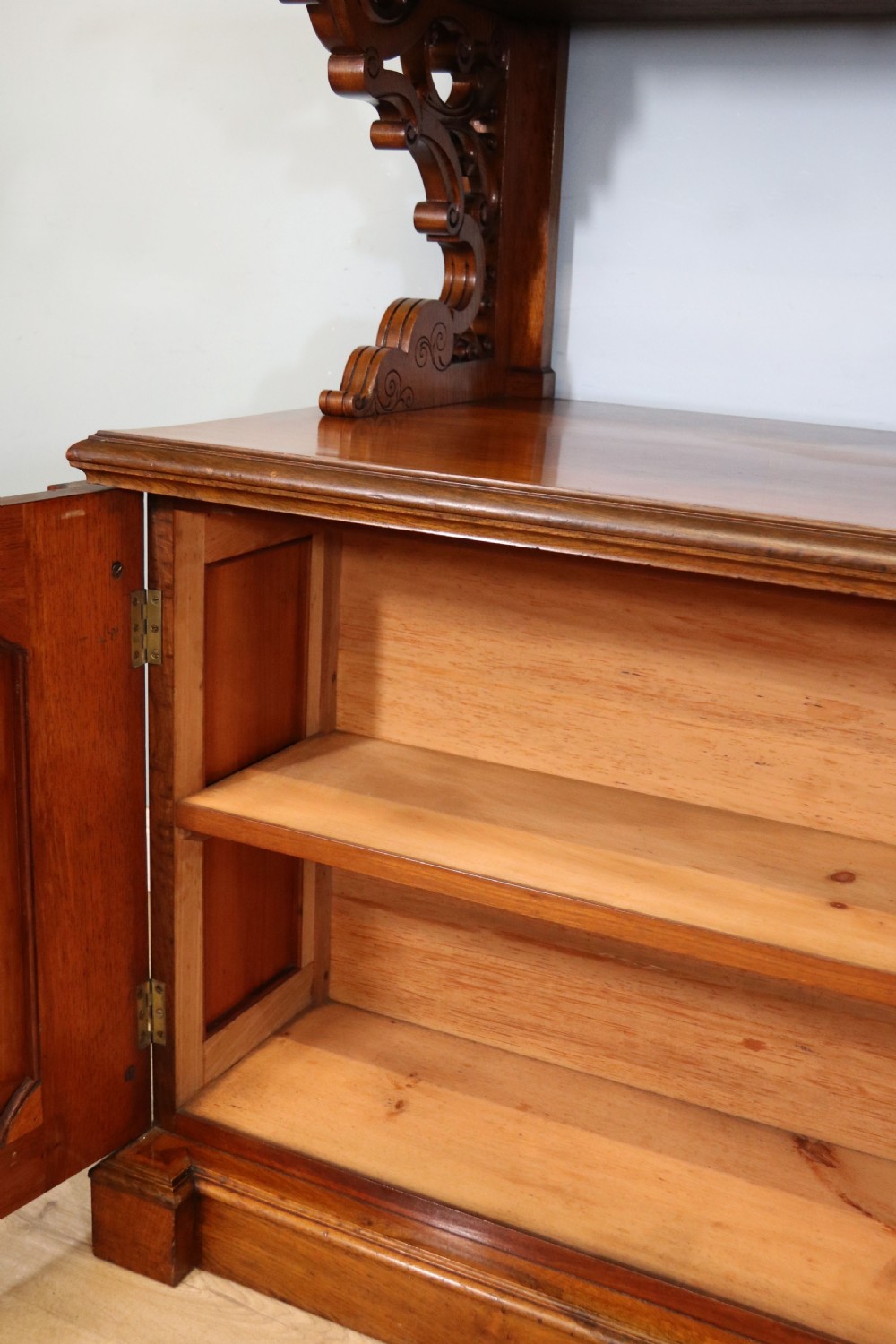 A Victorian pollard oak sideboard featuring a carved upper display shelf, fretwork cresting, and two fielded panel doors with decorative wood grain. View XXVII