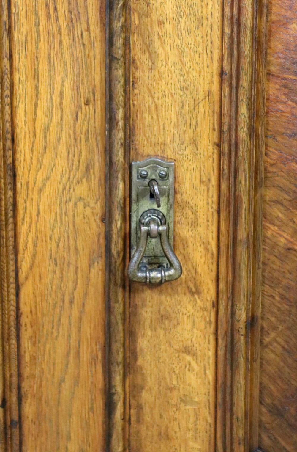 A Victorian pollard oak sideboard featuring a carved upper display shelf, fretwork cresting, and two fielded panel doors with decorative wood grain. View XXIX