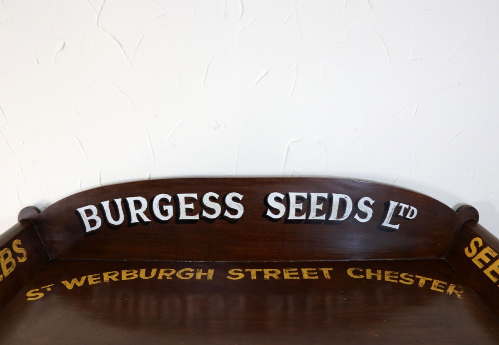 A late Victorian mahogany galleried side table featuring two drawers, turned legs on a trestle base, and painted commercial lettering. View VIII