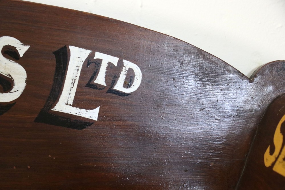 A late Victorian mahogany galleried side table featuring two drawers, turned legs on a trestle base, and painted commercial lettering. View XII
