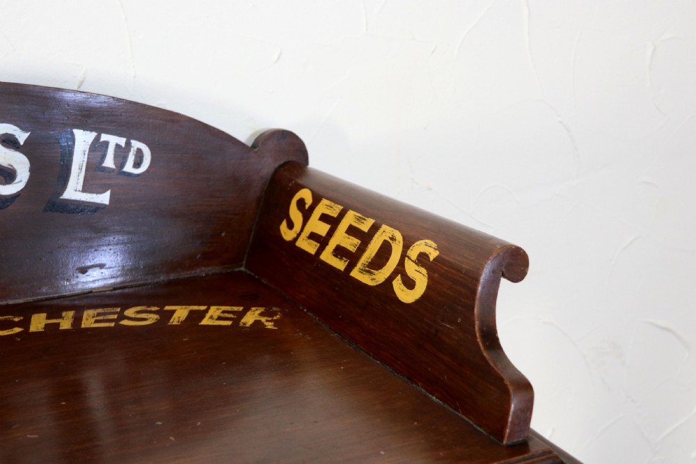 A late Victorian mahogany galleried side table featuring two drawers, turned legs on a trestle base, and painted commercial lettering. View XIII