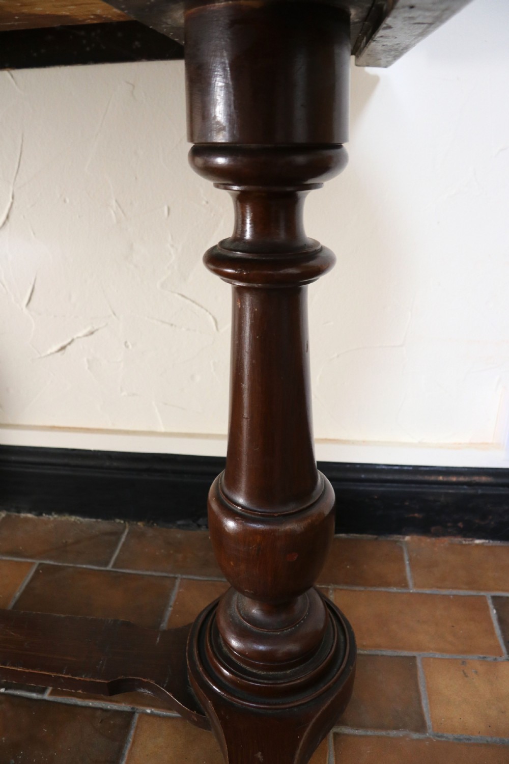 A late Victorian mahogany galleried side table featuring two drawers, turned legs on a trestle base, and painted commercial lettering. View XVII