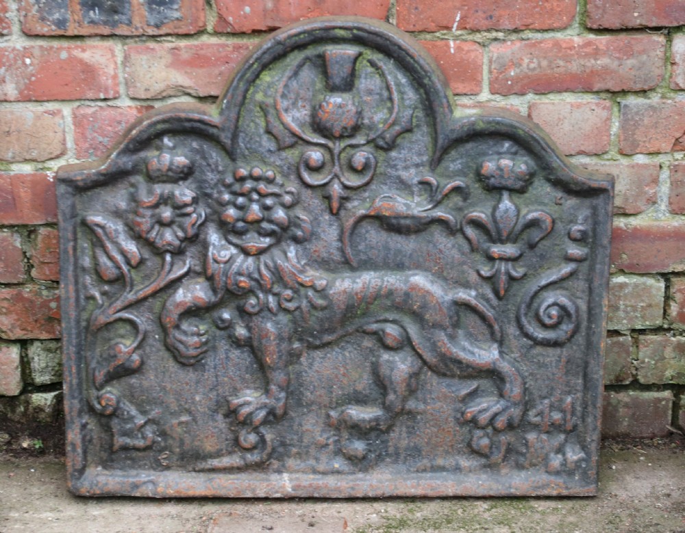 A cast iron fire back in the medieval style with passant guardant leopard.