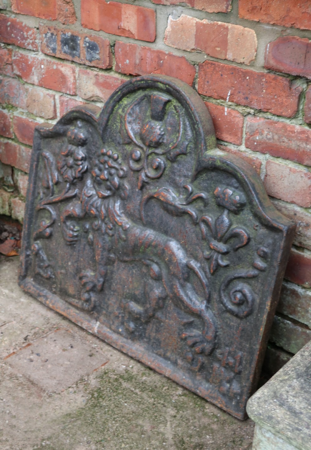 A cast iron fire back in the medieval style with passant guardant leopard. View II