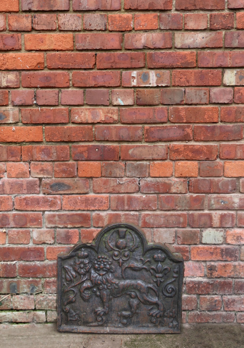A cast iron fire back in the medieval style with passant guardant leopard. View IV