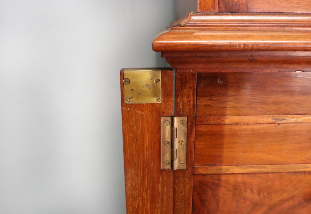 A tall Victorian solid walnut shop cabinet with glazed upper doors featuring sign-written fishing typography, multiple small drawers in the midsection, and panelled cupboard doors below. View XXV