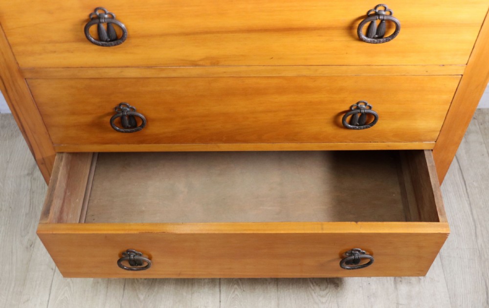 A late Victorian American walnut chest of drawers featuring four full-width drawers with metal drop-ring handles, a low shaped gallery upstand, and turned feet. View IX