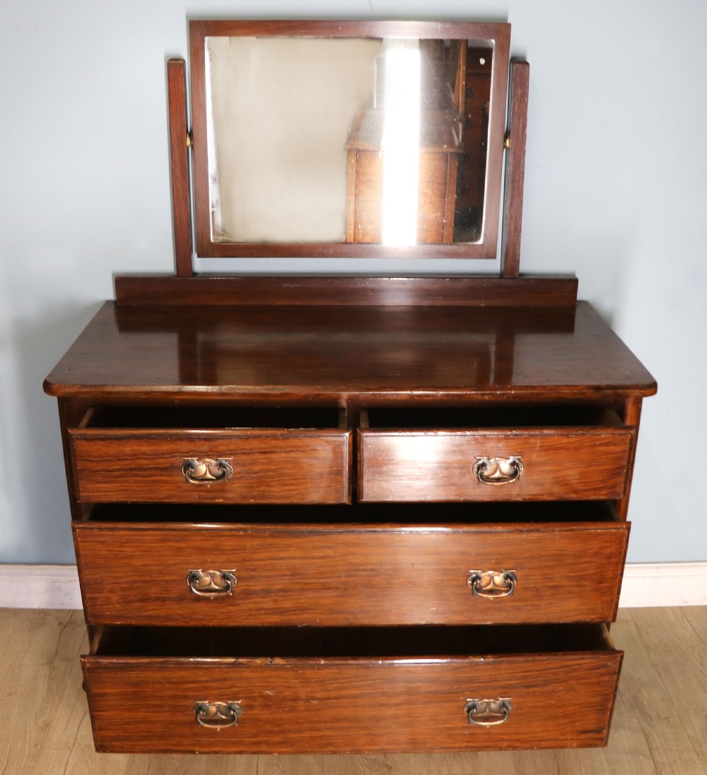 A dark mahogany Victorian dressing chest featuring a rectangular pivoting top mirror and four drawers with metal drop handles. View II