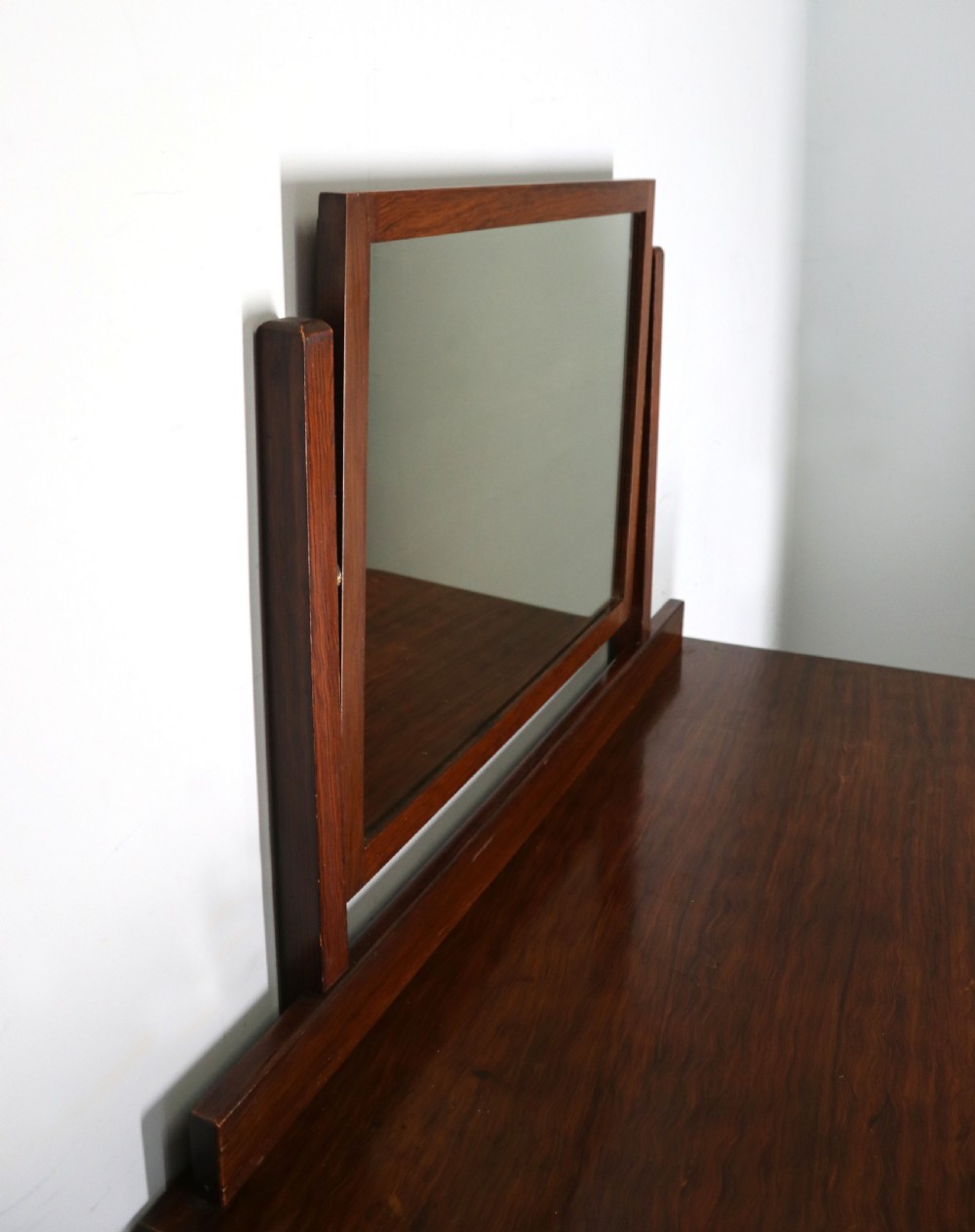 A dark mahogany Victorian dressing chest featuring a rectangular pivoting top mirror and four drawers with metal drop handles. View VII