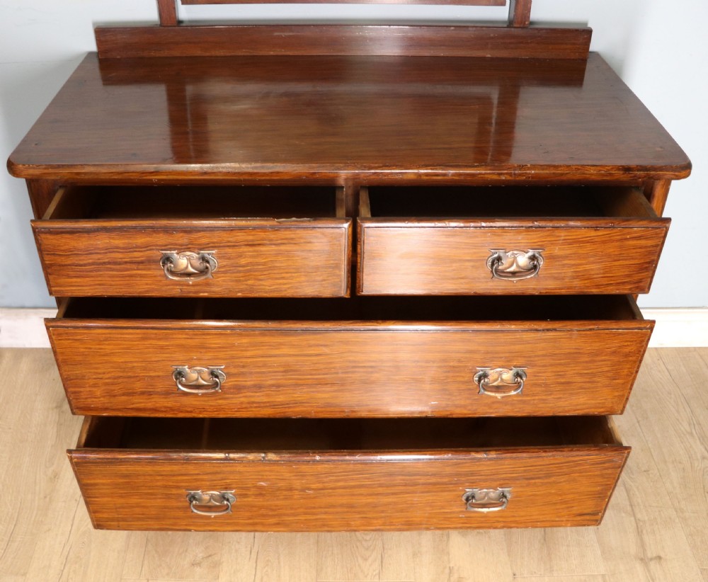 A dark mahogany Victorian dressing chest featuring a rectangular pivoting top mirror and four drawers with metal drop handles. View XI