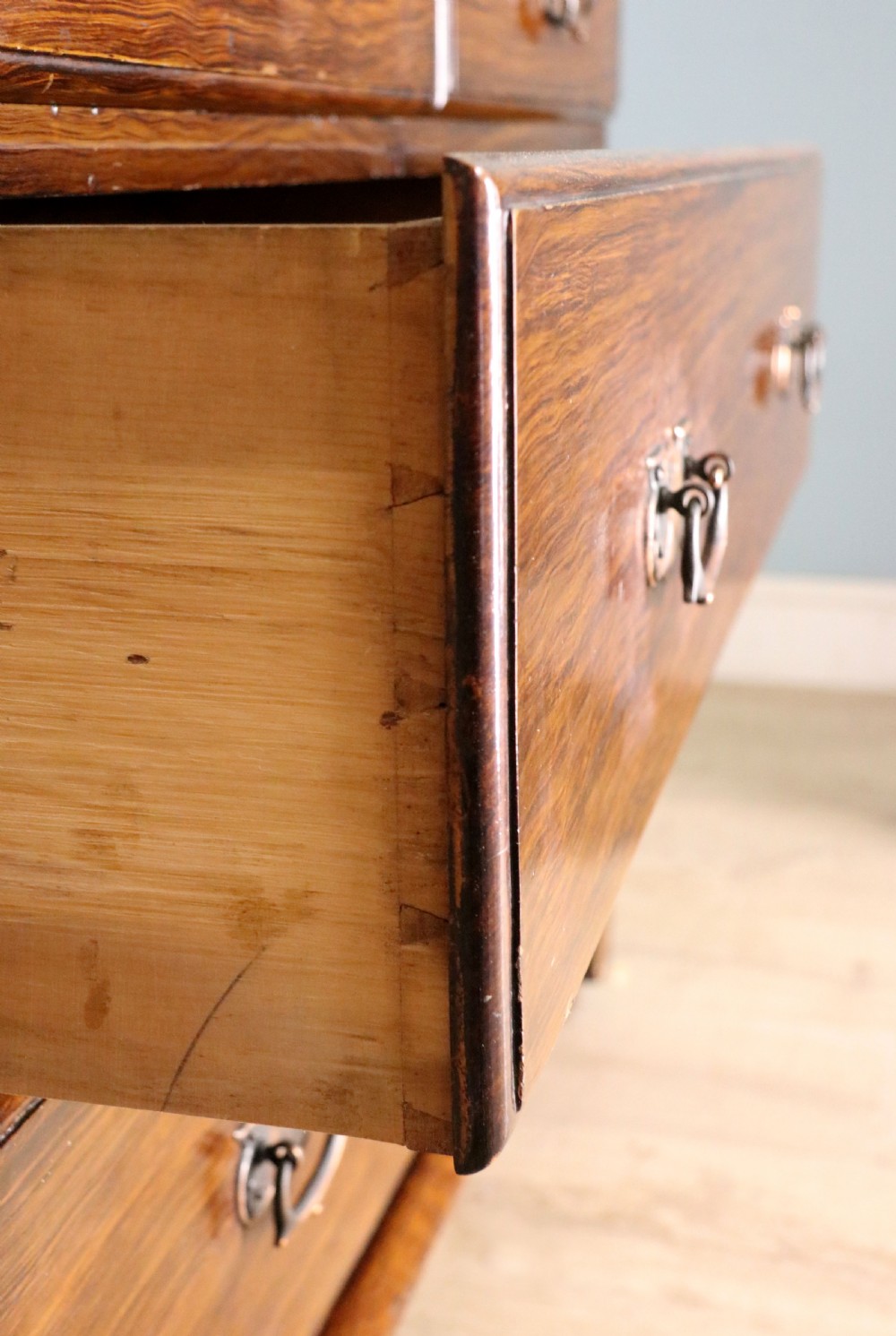 A dark mahogany Victorian dressing chest featuring a rectangular pivoting top mirror and four drawers with metal drop handles. View XV