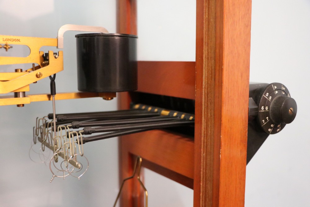 An Oertling precision chemists beam balance scale with a brass mechanism housed inside a glazed timber cabinet featuring gilded gold typography. View VI