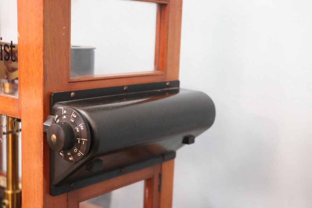 An Oertling precision chemists beam balance scale with a brass mechanism housed inside a glazed timber cabinet featuring gilded gold typography. View XI