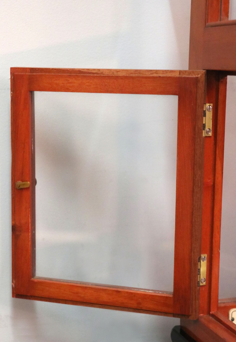 An Oertling precision chemists beam balance scale with a brass mechanism housed inside a glazed timber cabinet featuring gilded gold typography. View XII