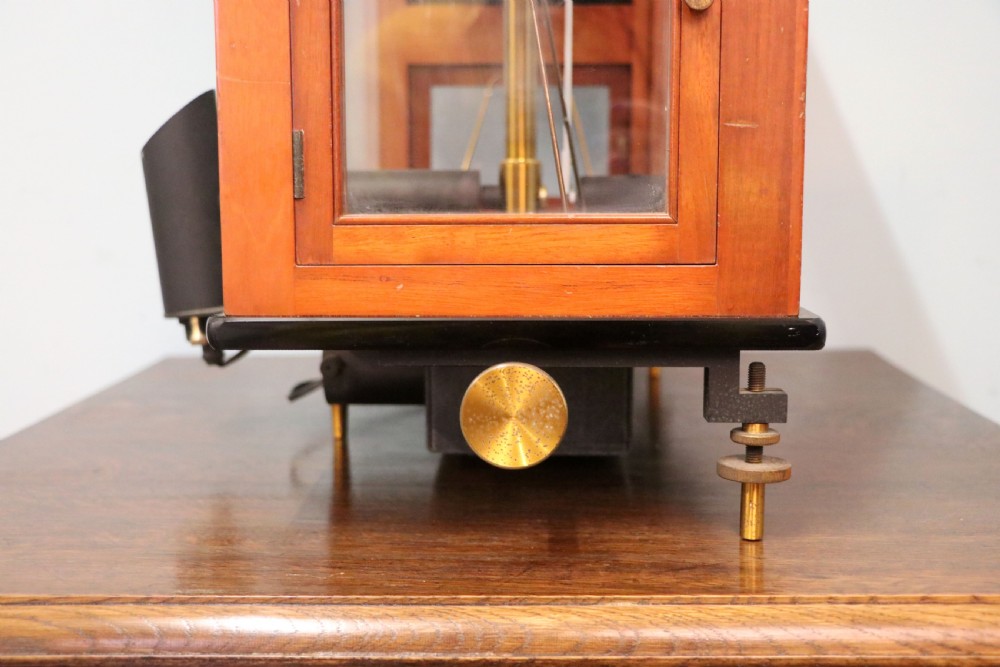 An Oertling precision chemists beam balance scale with a brass mechanism housed inside a glazed timber cabinet featuring gilded gold typography. View XIV