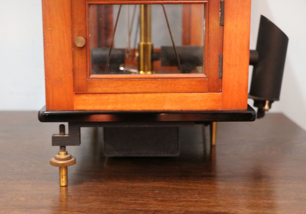 An Oertling precision chemists beam balance scale with a brass mechanism housed inside a glazed timber cabinet featuring gilded gold typography. View XV