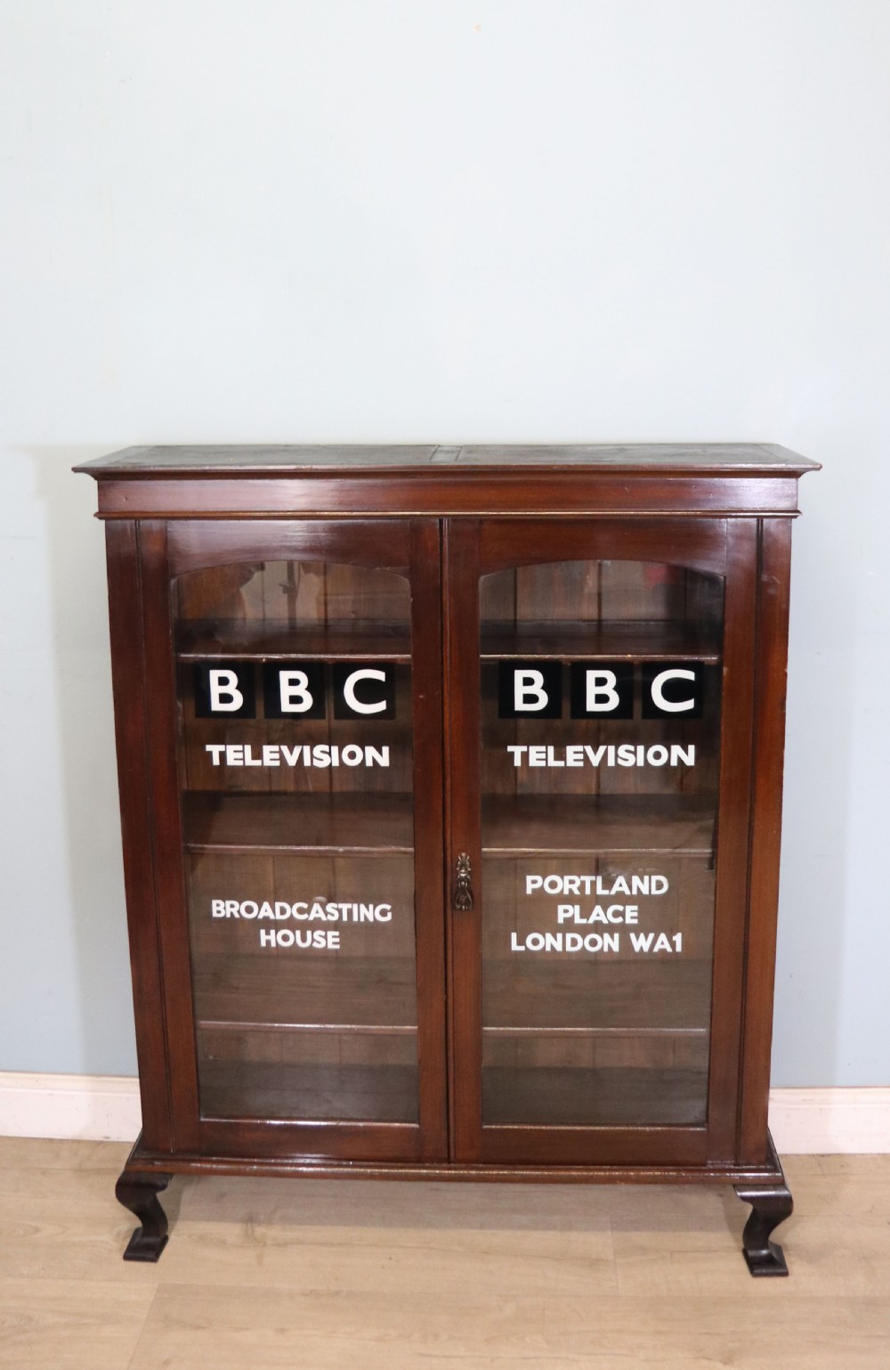  A lovely early 20th century mahogany framed glazed bookcase cabinet, later sign written for the (BBC)