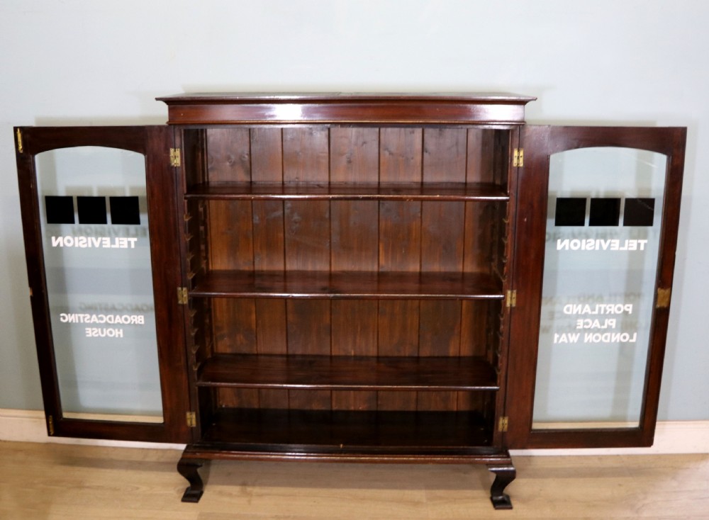  A lovely early 20th century mahogany framed glazed bookcase cabinet, later sign written for the (BBC) View II