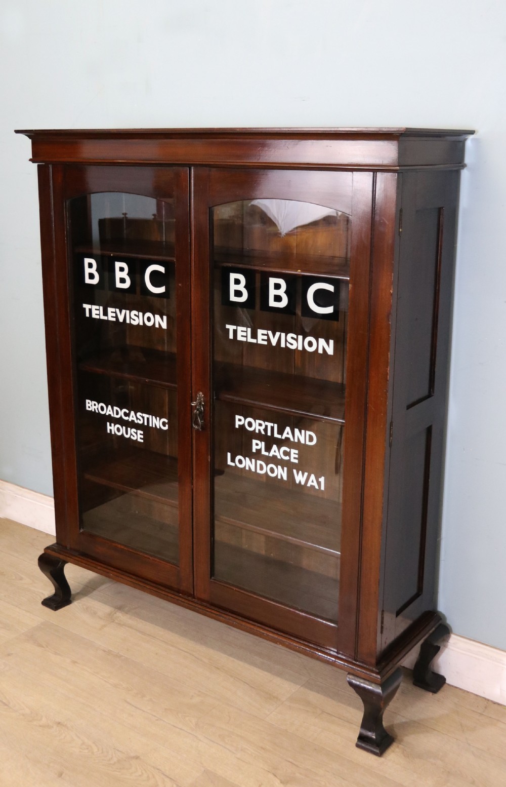 A lovely early 20th century mahogany framed glazed bookcase cabinet, later sign written for the (BBC) View III