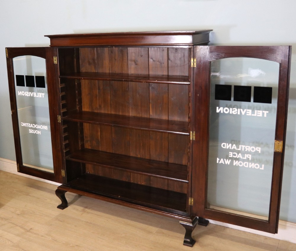  A lovely early 20th century mahogany framed glazed bookcase cabinet, later sign written for the (BBC) View IV