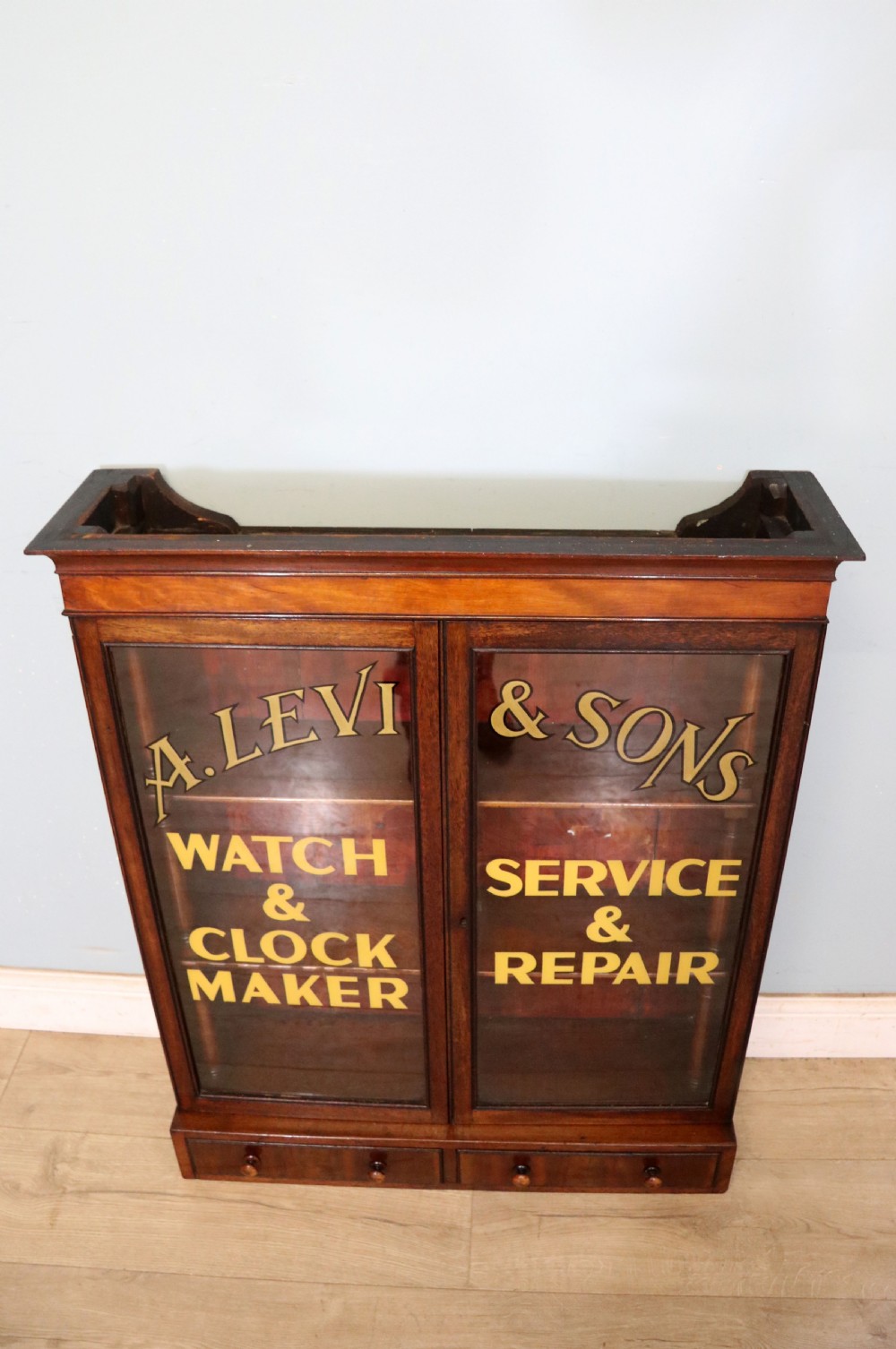 A quality mahogany shop display cabinet, later sign written for A.Levi  watch and clockmakers. View II
