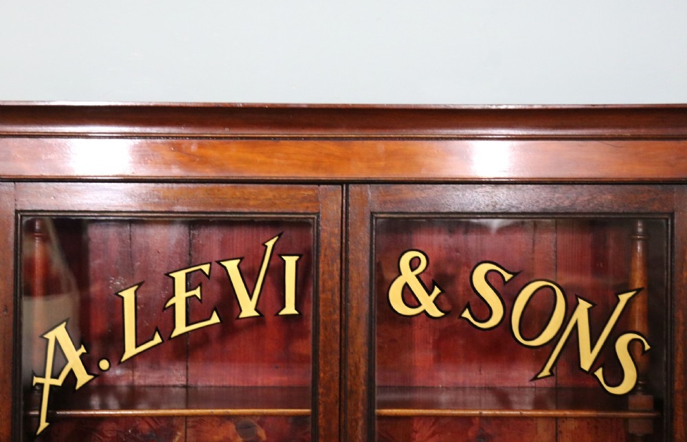 A quality mahogany shop display cabinet, later sign written for A.Levi  watch and clockmakers. View IV