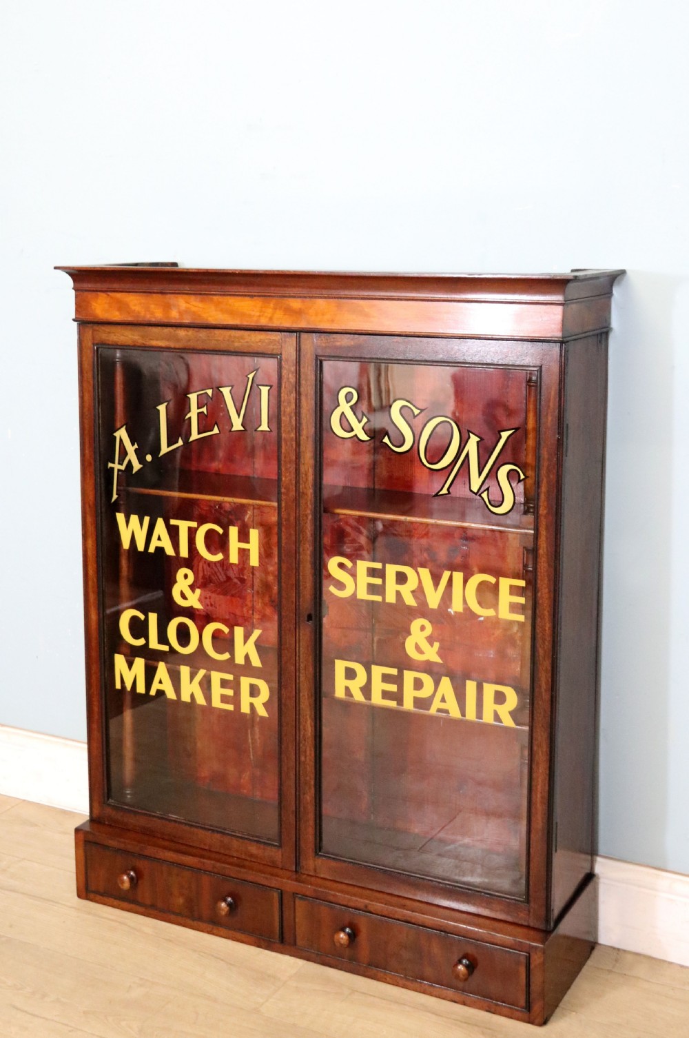 A quality mahogany shop display cabinet, later sign written for A.Levi  watch and clockmakers. View IX
