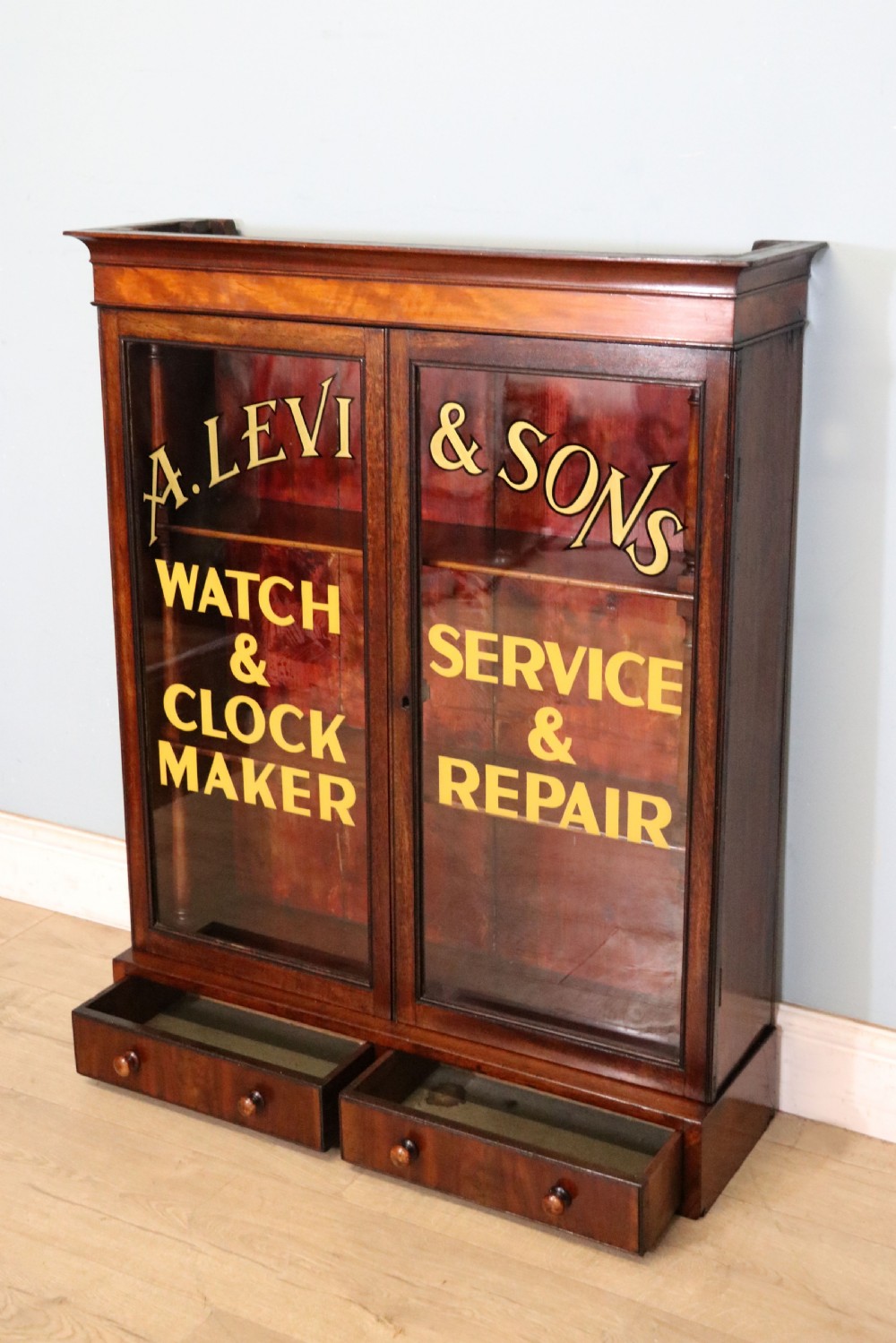 A quality mahogany shop display cabinet, later sign written for A.Levi  watch and clockmakers. View X