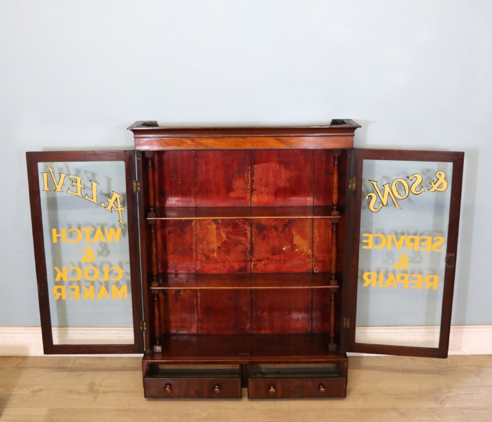 A quality mahogany shop display cabinet, later sign written for A.Levi  watch and clockmakers. View XII