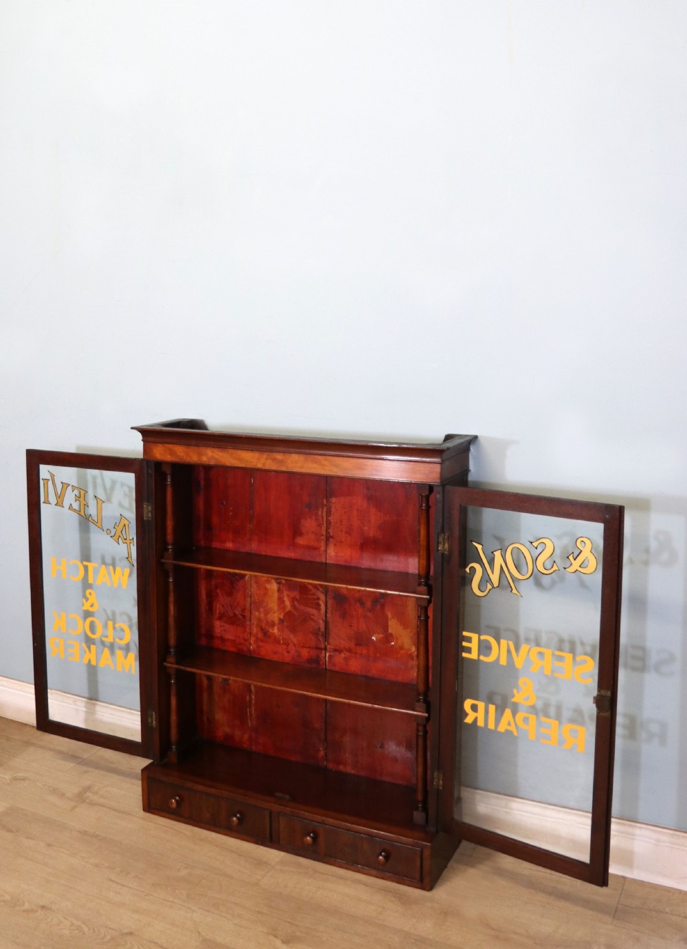 A quality mahogany shop display cabinet, later sign written for A.Levi  watch and clockmakers. View XIII