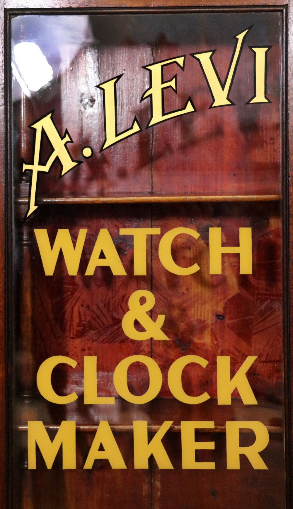 A quality mahogany shop display cabinet, later sign written for A.Levi  watch and clockmakers. View XVII