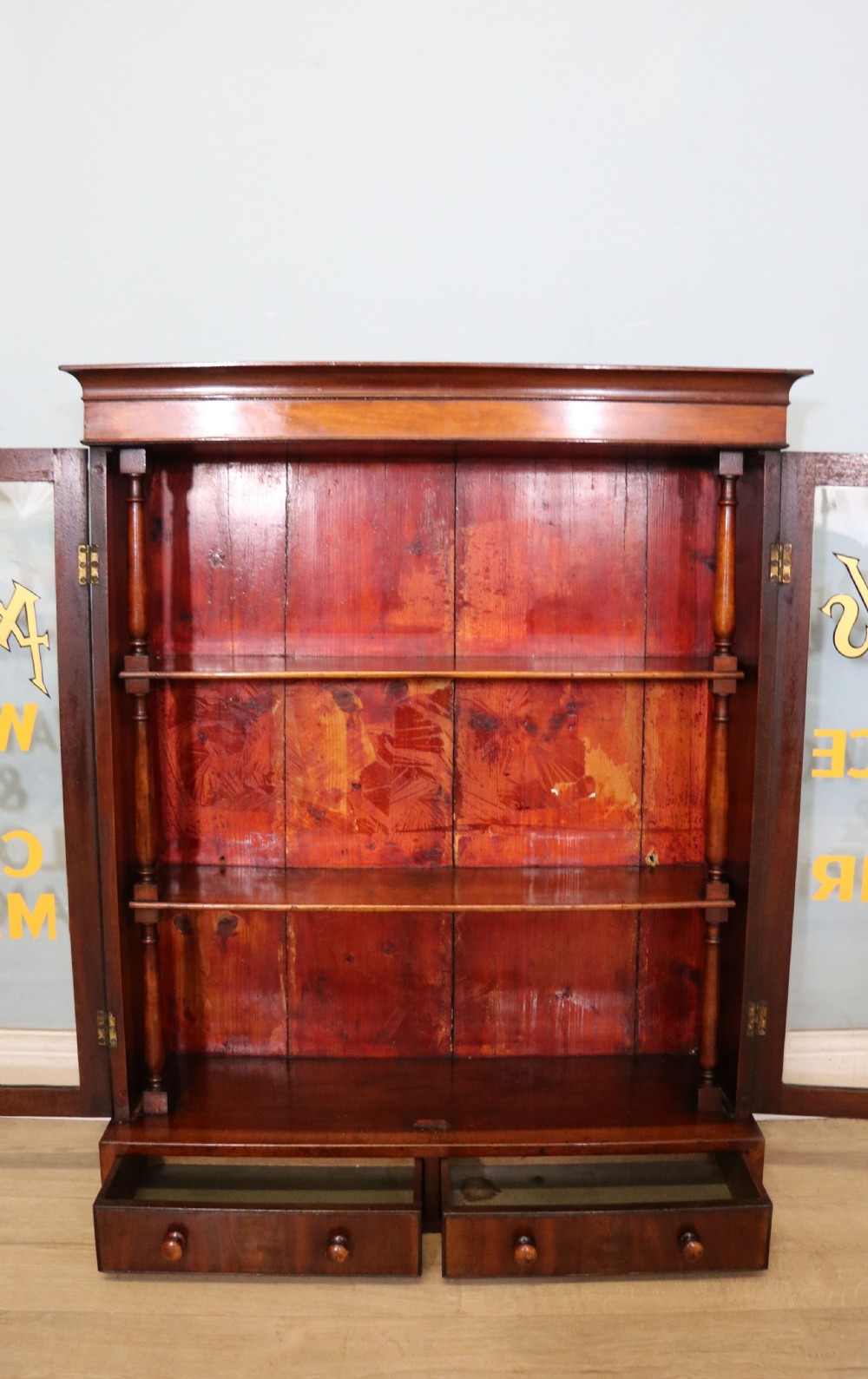A quality mahogany shop display cabinet, later sign written for A.Levi  watch and clockmakers. View XXI