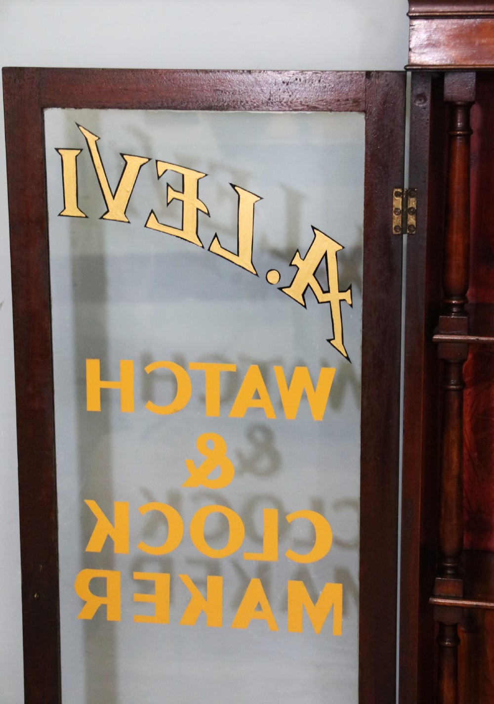 A quality mahogany shop display cabinet, later sign written for A.Levi  watch and clockmakers. View XXVI