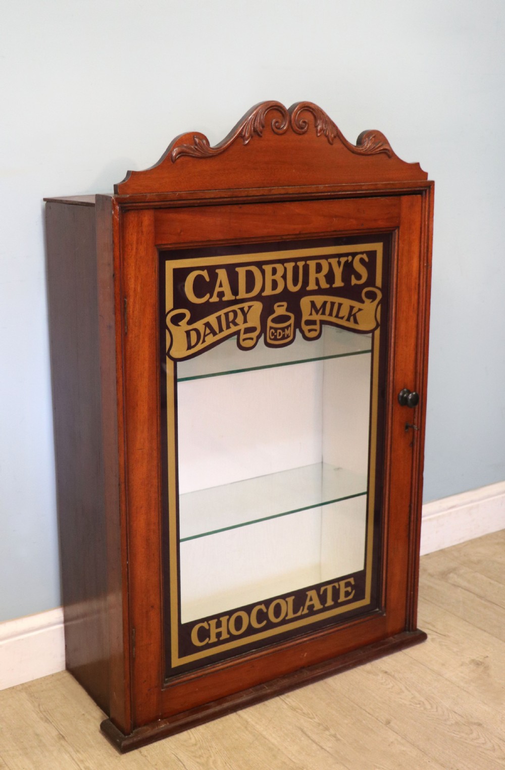 A lovely mahogany framed wall mounted display cabinet hand sign written for Cadburys Chocolate View II